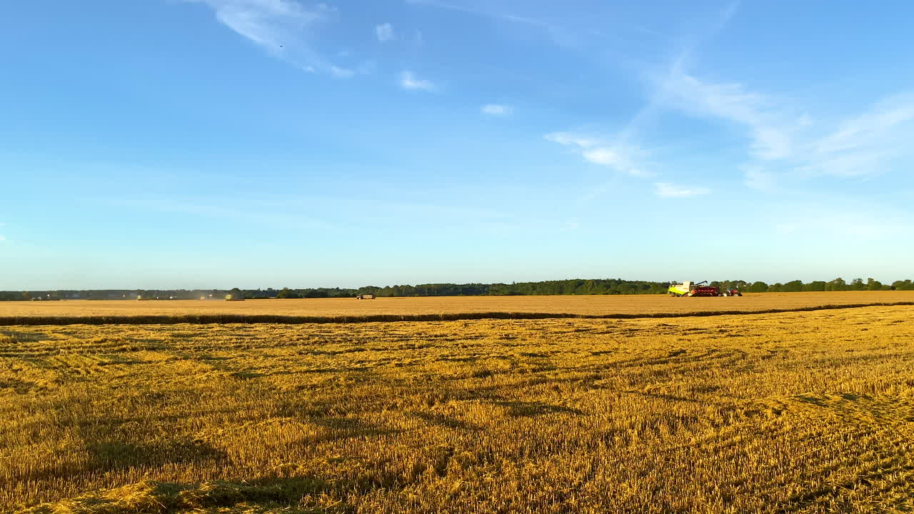 Golden Fields with Farmers working Tractors and Combine Harvesters in Slow motion - High Frame Rate
