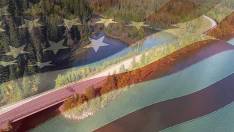 animation of american flag over aerial view of forest and river