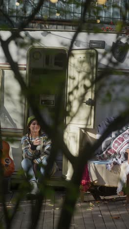 woman relaxing in a camper van in autumn