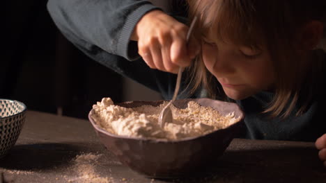 little girl scoop baking flour mix in bowl in home kitchen, preparing ingredient