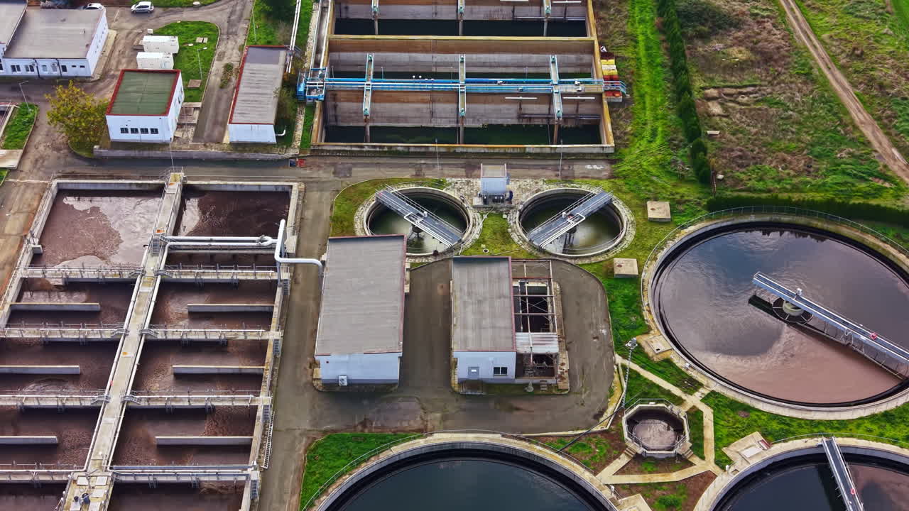 Exploring the intricate design and sustainable processes of a modern wastewater treatment plant in a green landscape