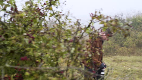 wildlife photographer with a dslr camera taking photos in bushes,mist