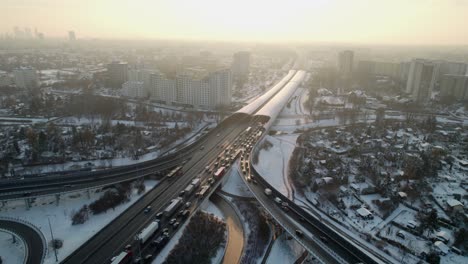 Treffic-in-snow-intersection-road-at-sunset-in-the-city-of-Warsaw-in-Poland-at-winter