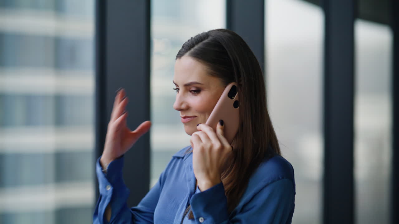 Professional manager consulting smartphone looking in office window closeup