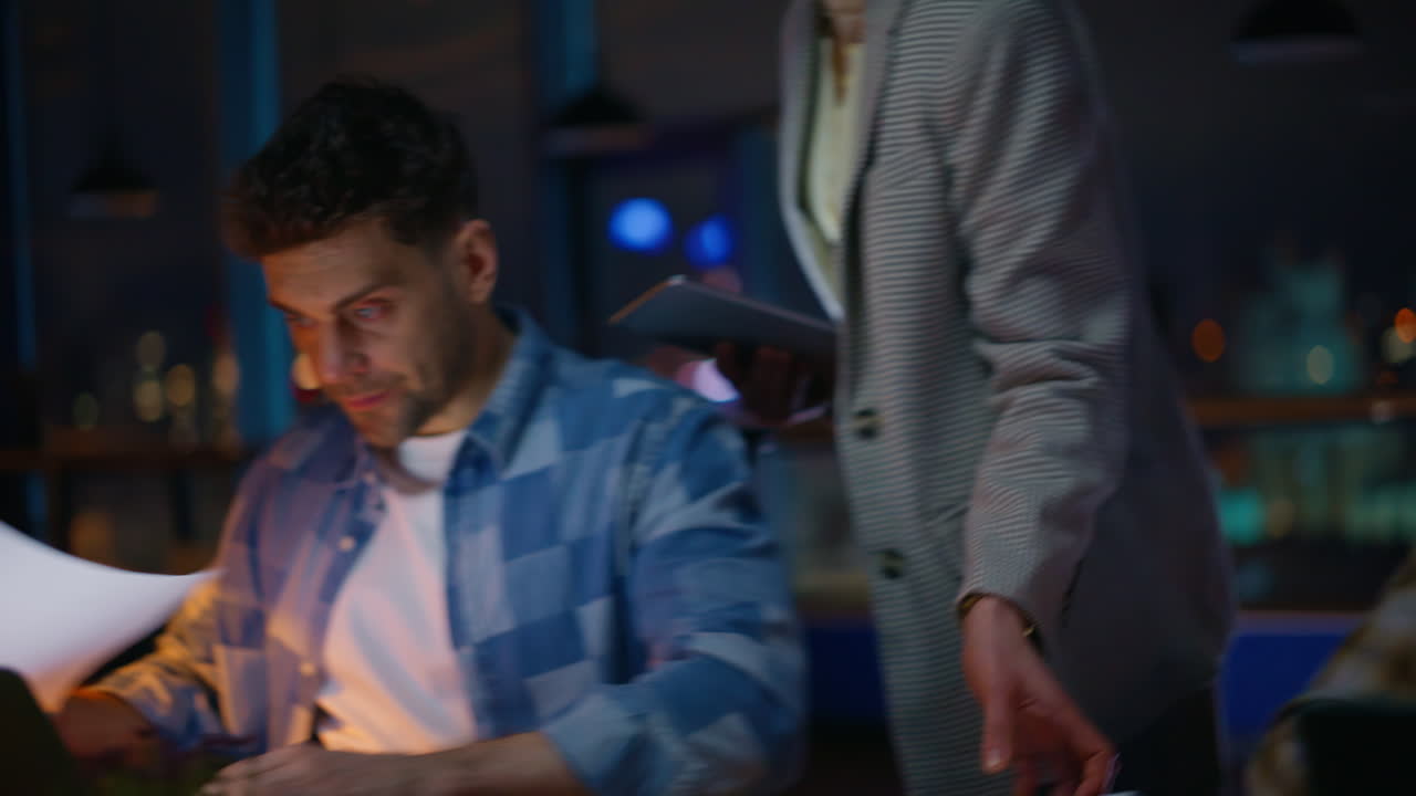 Woman expert helping interns evening office closeup. Mentor giving instructions