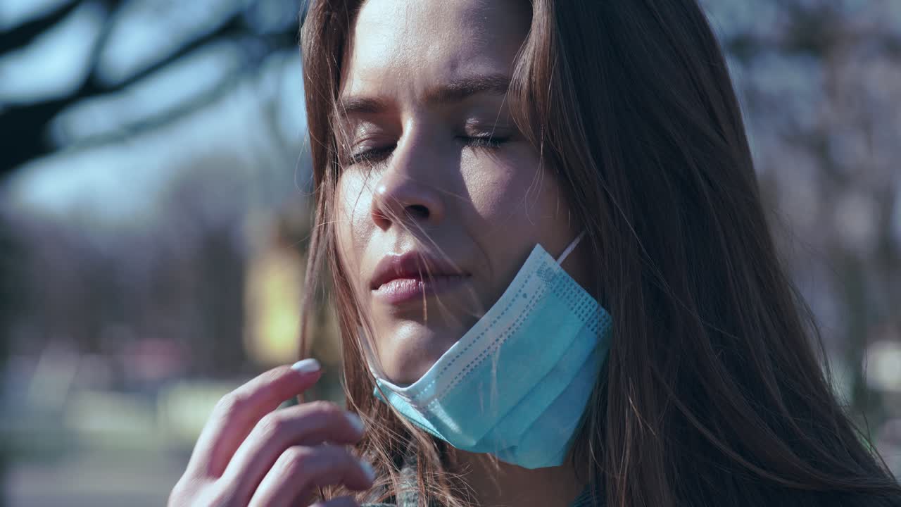Woman wearing a face mask in a park