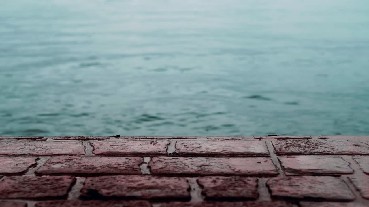 Monotone Red Brick Stone Pavement Pier Beside Blue Sea under Rain 4K.
