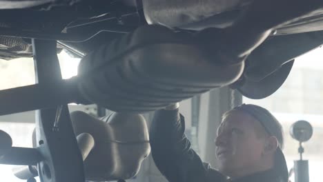 car mechanic working under a vehicle