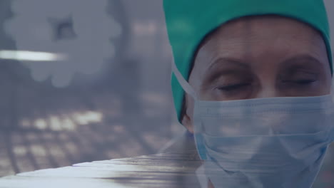 portrait of female surgeon wearing face mask against time-lapse of people walking