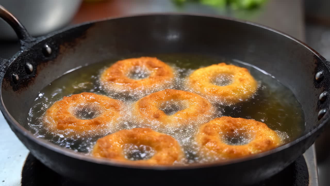 Deep-frying golden donuts in a pan