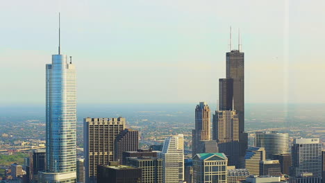 downtown chicago city skyline from the 94th floor or the john hancock building. the trump and willis tower are shown.