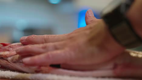 a shot captures fish being picked up as a towel is placed for preparation, filmed at 120 fps to highlight smooth motion and detail. perfect for culinary, seafood, and food preparation content.