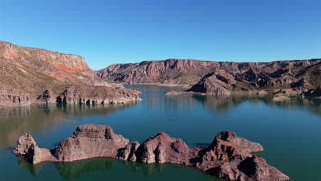 aerial view of atuel canyon in mendoza, argentina, reservoir surrounded by dramatic rock formations