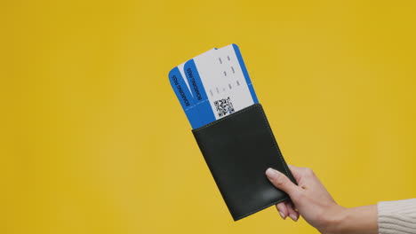 hand holding passport with boarding pass