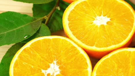 top view rotate of orange slice on green leaves background, close up fresh orange sliced on white background and slowly rotating.