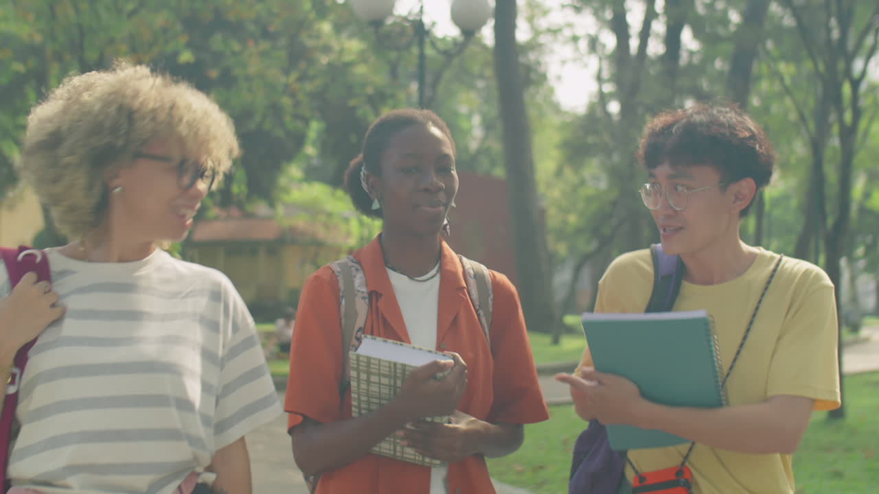 College Friends Chatting on Walk in Park