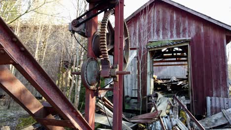 closeup of old timber saw mill ruins, abandoned shed and rotting junk in forest