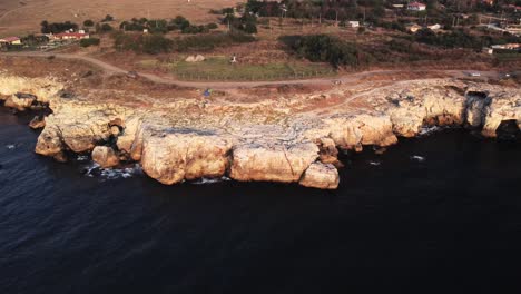 drone top down aerial view of waves splash against rocky seashore, background