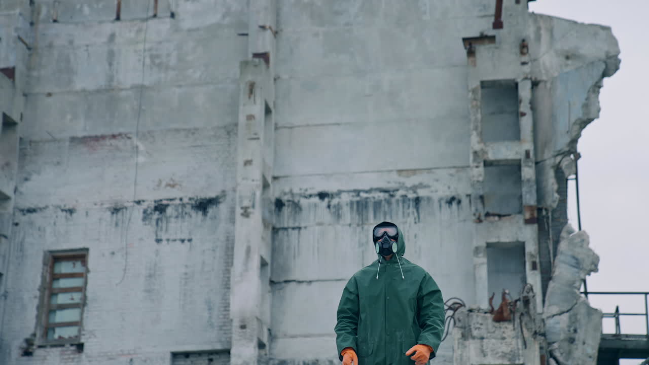 Human in gas mask among ruins. Man walking around in the post apocalyptic and ruined city