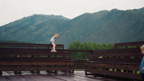 girl climbs on benches brother walks along dancing ground