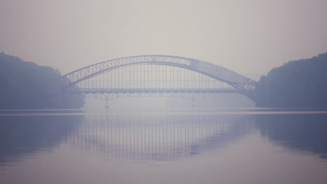 an ambulance speeds across a bridge on a day with heavy smoke pollution