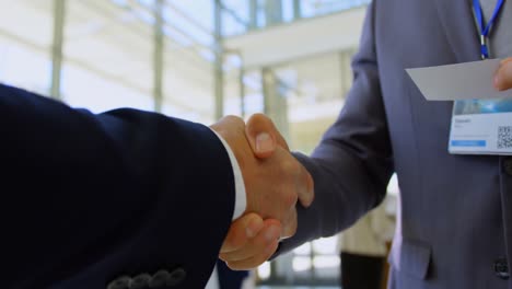 Multi-ethnic-business-people-shaking-hands-with-each-other-during-a-seminar-4k