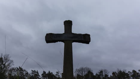 time lapse of grey and dark clouds passing over old gravestone