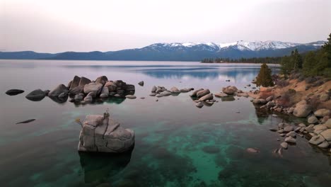 cloudy winter day south lake tahoe boulders sand harbor aerial drone california incline village crystal clear glassy turquoise water secret whale chimney kings beach shoreline forward motion