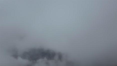 a pilot’s view taken from a jet airplane cockpit flying through fluffy stratus clouds under a deep blue sky. ultra-realistic4k shot