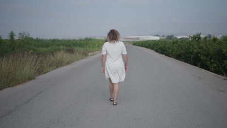 woman walking down a country road