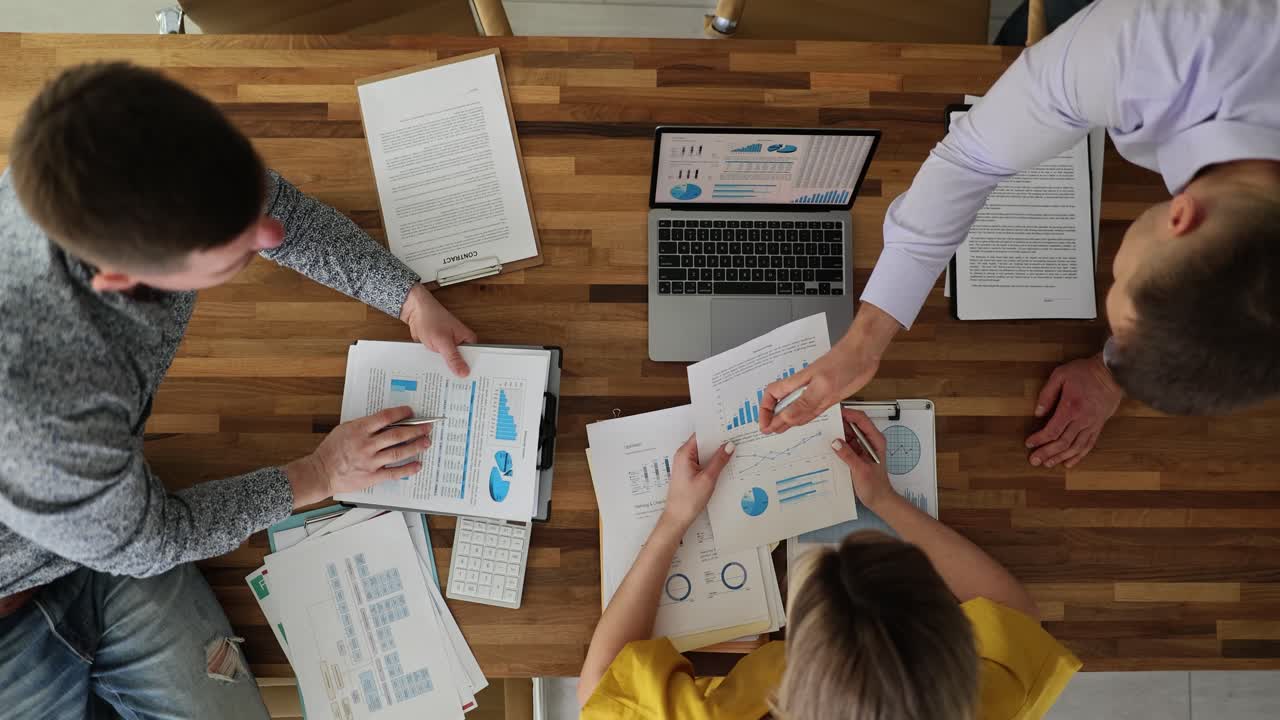 Overhead View of Business Meeting with Data Analysis and Collaboration