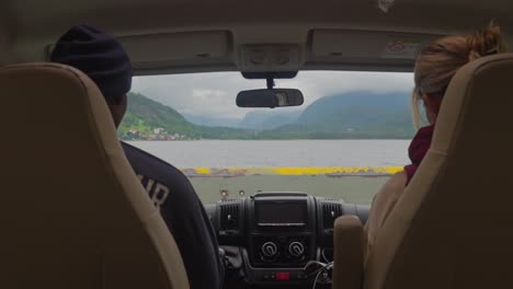 two people view a scenic ferry crossing in norway from the front seats of a vehicle