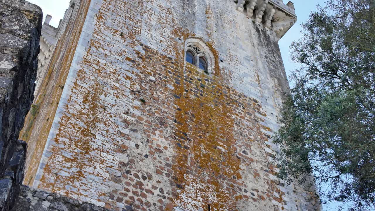 Low angle view of the medieval keep of Castle of Beja, a historic landmark in Portugal, exhibiting weathered stone walls and architectural details