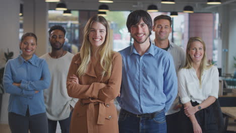 retrato de una pareja líder de un equipo de negocios multicultural de pie en una moderna oficina de plan abierto