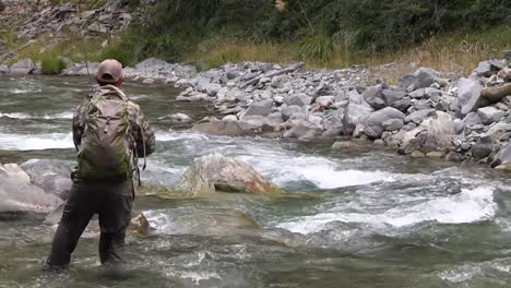 trout fly fishing in mountain river at summer