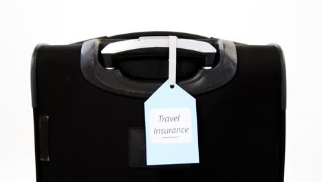 travel insurance label tied to a suitcase