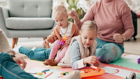 parents, kids and drawing on living room floor