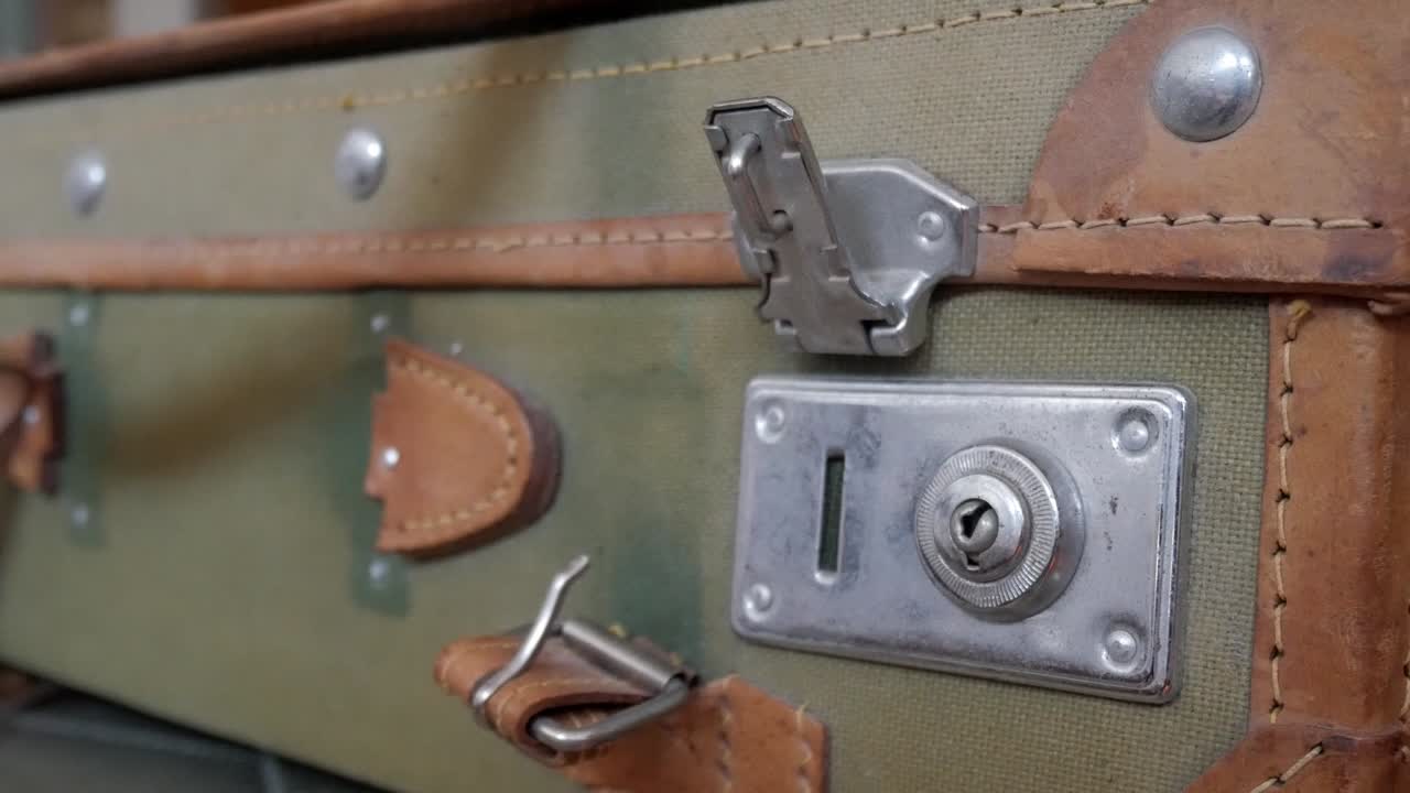 Vintage suitcase close-up with metal lock evokes travel and antiquities