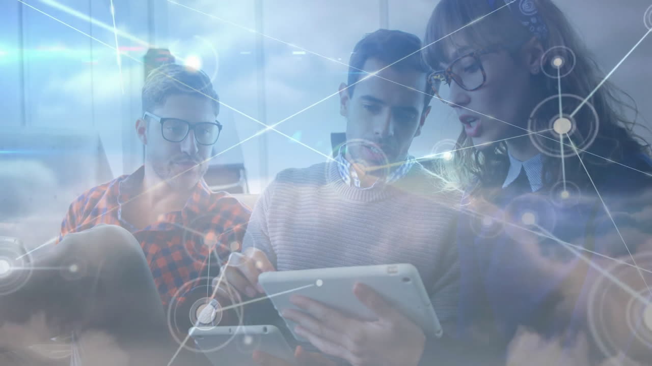 three colleagues collaborating over tablet in tech office lounge, with digital network nodes, lines