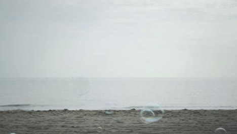 Bubbles-Flying-And-Floating-Over-The-Horizon-Of-Beach-View-Slow-Motion