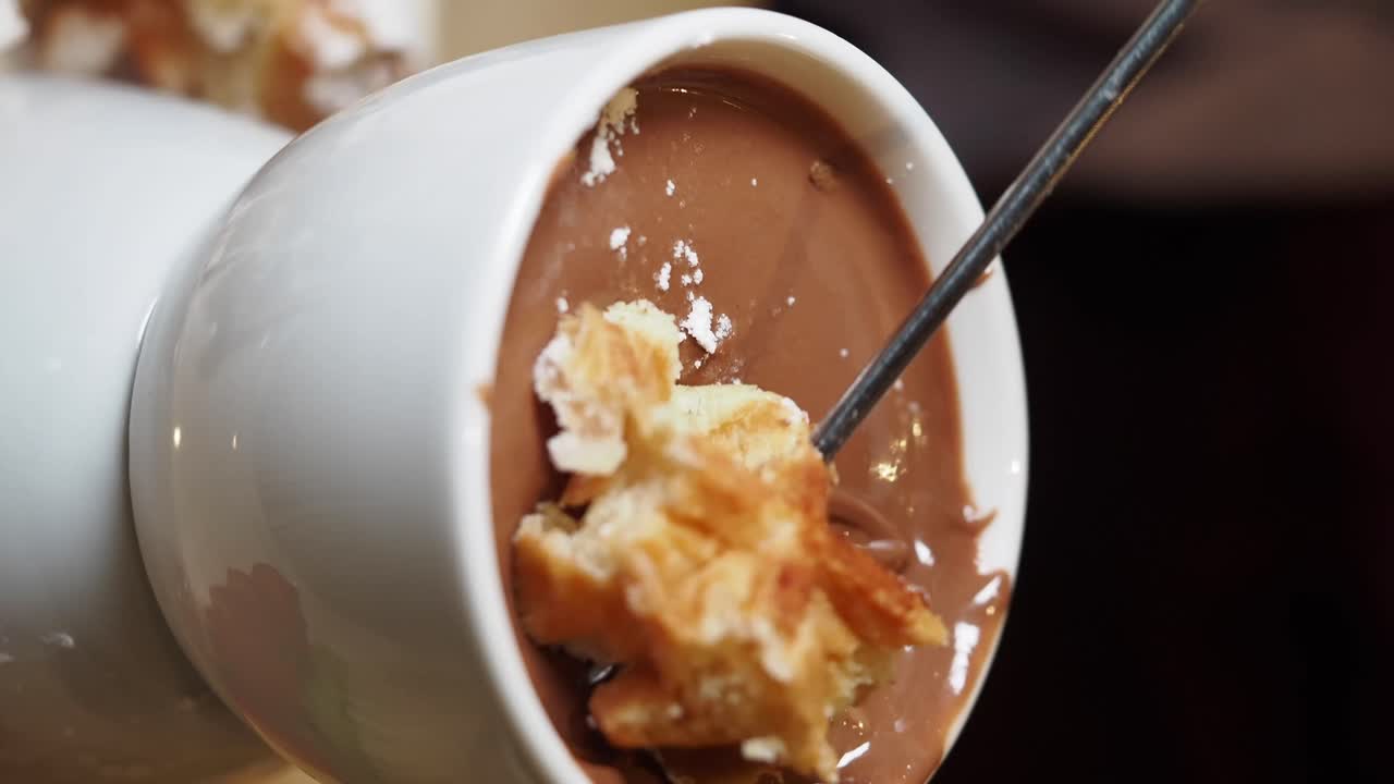 Dipping Pastry into Melted Chocolate