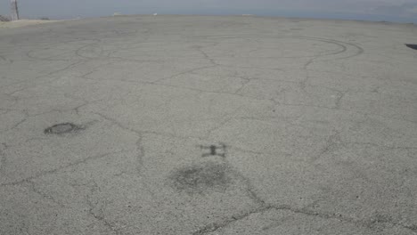 drone land on a concrete surface shot it's shadow