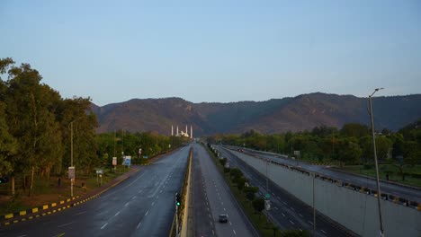 a morning time-lapse of faisal mosque islamabad while the sun is rising on margala hills