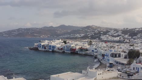 Reveal-of-the-windmills-of-Mykonos-with-Little-Venice-in-the-background