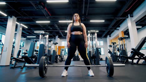 plus-size woman weightlifting in gym