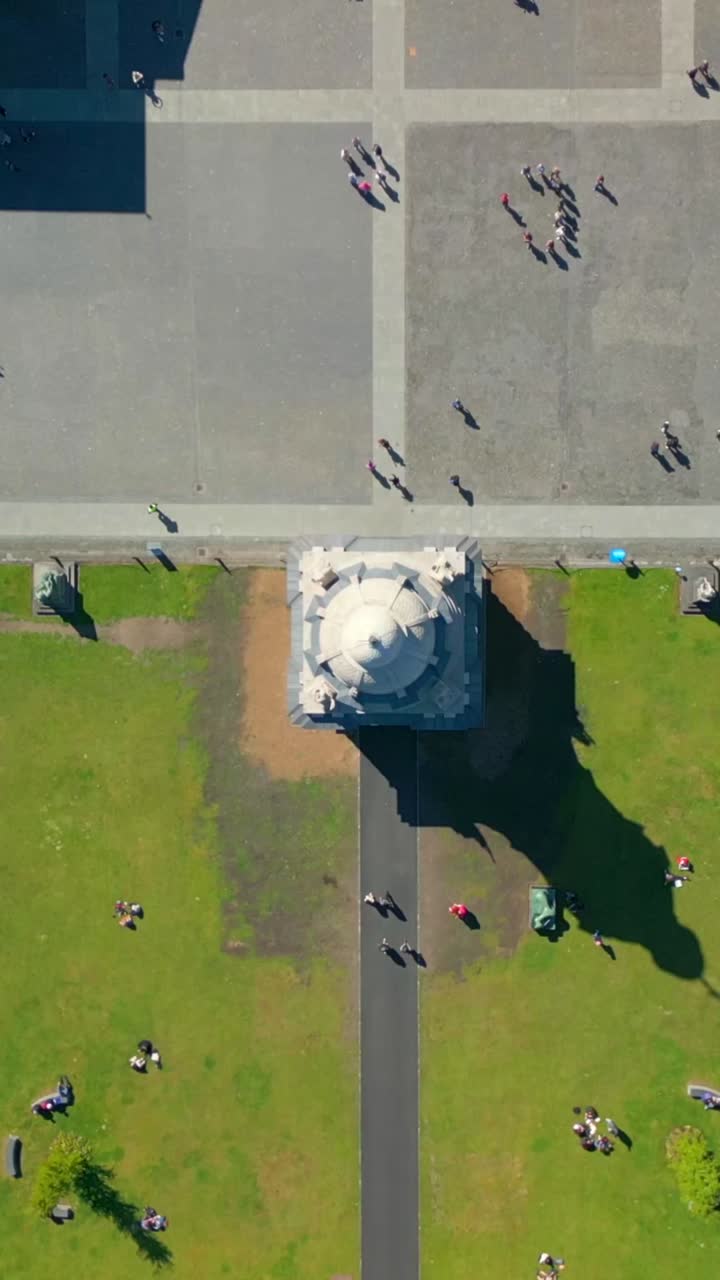 Rising overhead social ratio aerial video of the grounds of Trinity College Dublin on a bright and sunny day. Filmed in 1080x1920 and with Rec709 color