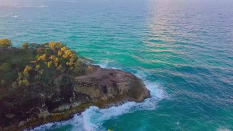 tilting down aerial shot of a cliff and vegetation