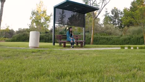 girl sits on a bench in the park