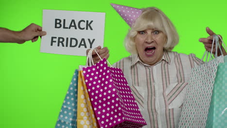 Advertisement-inscription-Black-Friday-appears-next-to-joyful-grandmother-with-shopping-bags