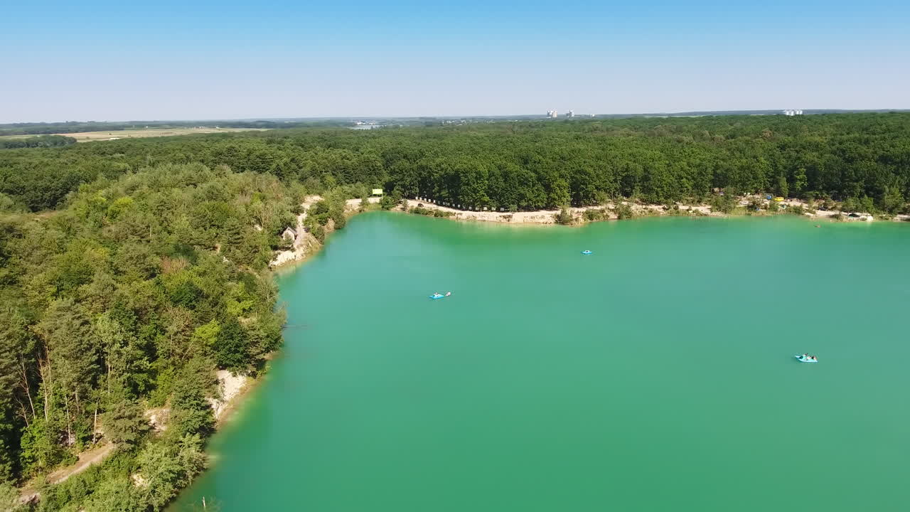 Aerial View of Turquoise Lake Surrounded by Forest
